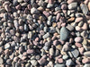These colored landscaping rocks from Kilgore Landscape Center are Rainbow Beach Cobble dry